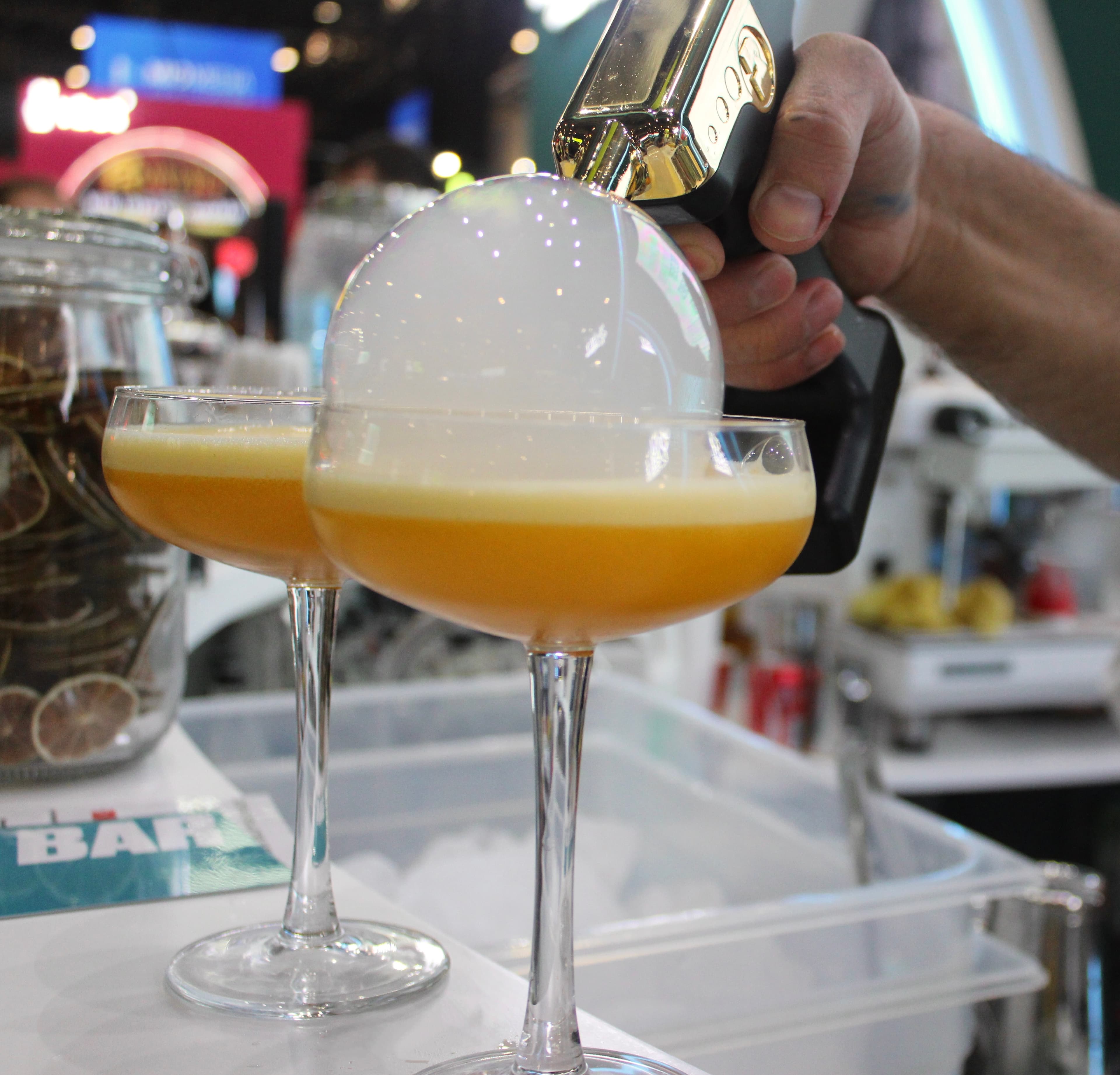 Two bartenders preparing drinks at customer's wedding cocktail bar