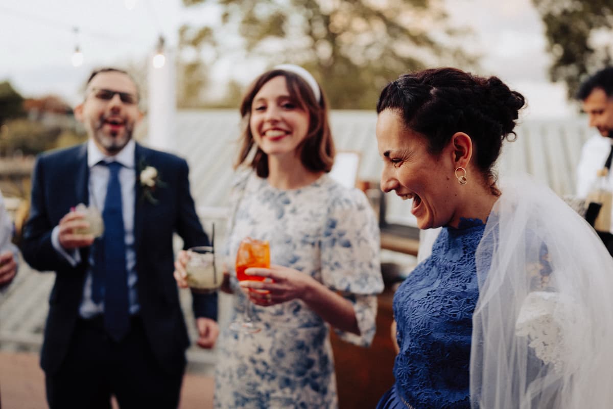 Happy guests holding cocktails at The Game Fair event for Whisky 1901.