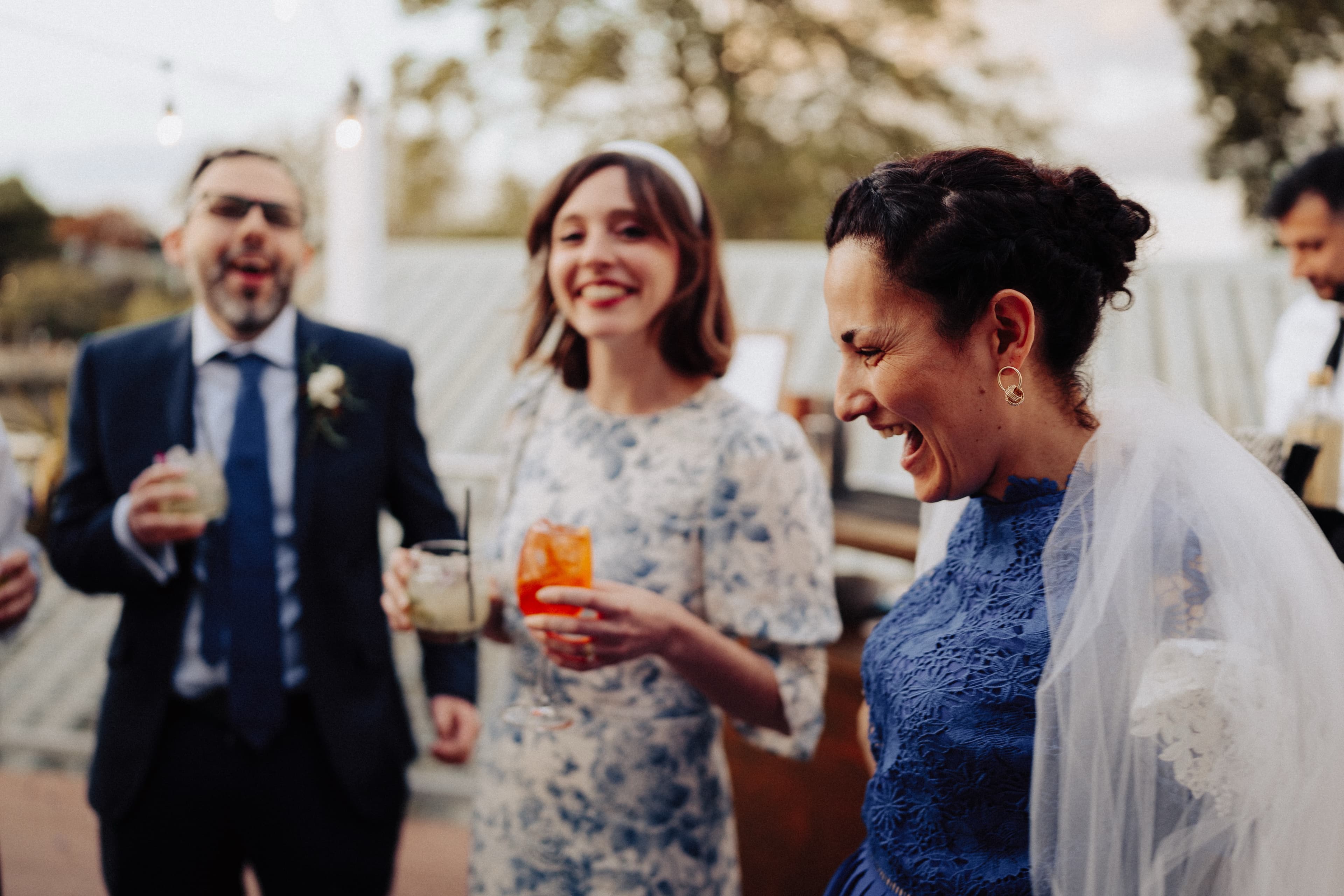 Happy guests holding cocktails at The Game Fair event for Whisky 1901.